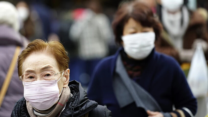 Menschen tragen Gesichtsmasken in einem Einkaufsviertel in Tokio. (Archivbild)