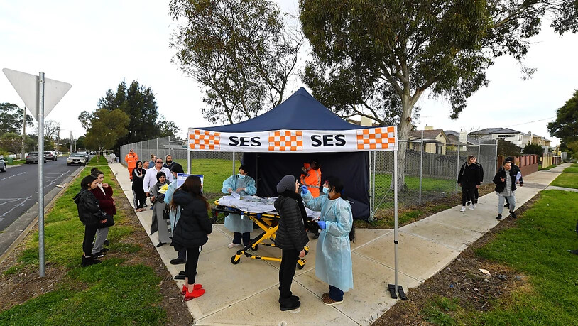 A person receives a COVID-19 test at a Coronavirus pop-up testing facility in Broadmeadows, Melbourne, Friday, June 26, 2020. Coronavirus pop-up testing facilities have been setup in residential streets throughout area's considered coronavirus hotspots…
