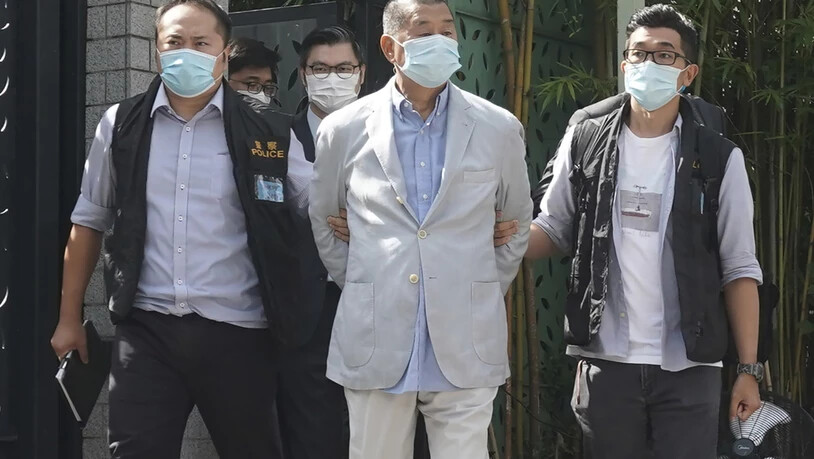 dpatopbilder - Jimmy Lai (M), Medien-Tycoon in Hongkong und Gründer der Lokalzeitung Apple Daily, wird in seinem Haus in Hongkong von Polizeibeamten verhaftet. Foto: -/AP/dpa