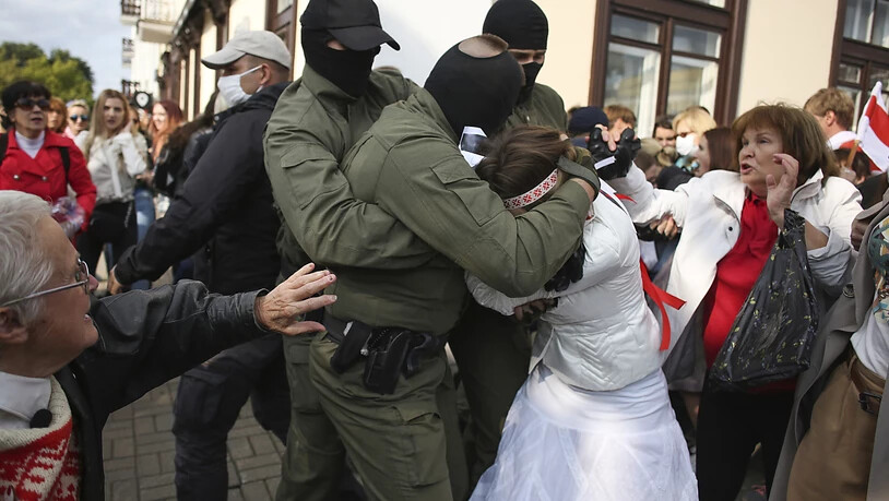 Polizisten nehmen eine Demonstrantin fest. Foto: -/Tut.by/AP/dpa