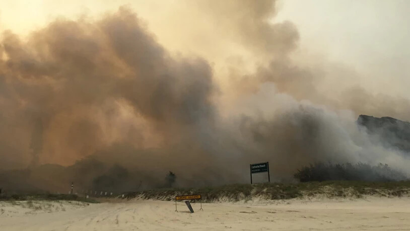 A supplied image obtained on Monday, December 7, 2020, the K'gari (Fraser Island) bushfire seen outside the Cathedrals camping ground, on Fraser Island. TA dangerous bushfire is within a few hundred metres of Happy Valley as dozens of firefighters battle…