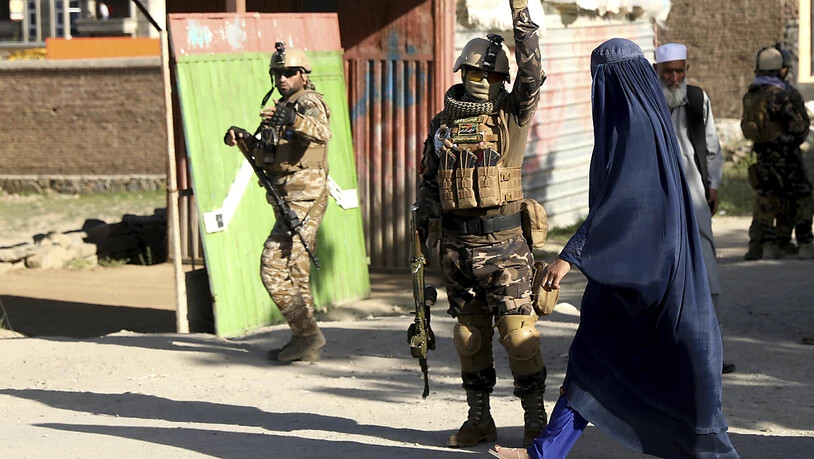 Sicherheitskräfte arbeiten am Anschlagsort nördlich der Hauptstadt Kabul im Distrikt Schakar Dara. Bei dem Anschlag sind mindestens zwölf Menschen getötet worden. Foto: Rahmat Gul/AP/dpa