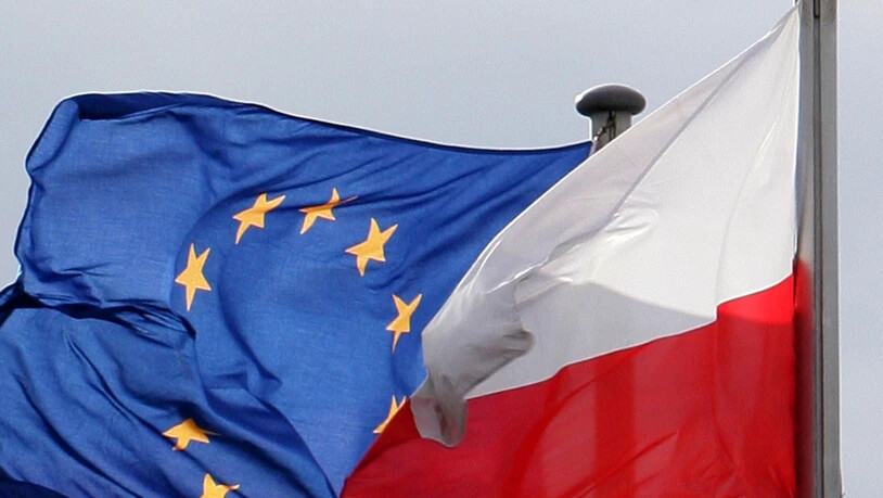 ARCHIV - Die Fahnen der Europäischen Union (EU) und von Polen wehen am deutsch-polnischen Grenzübergang. Eine am Dienstag veröffentlichten Befragung von United Surveys ergab, dass eine überwältigende Mehrheit der Polen dafür ist, dass ihr Land weiterhin…
