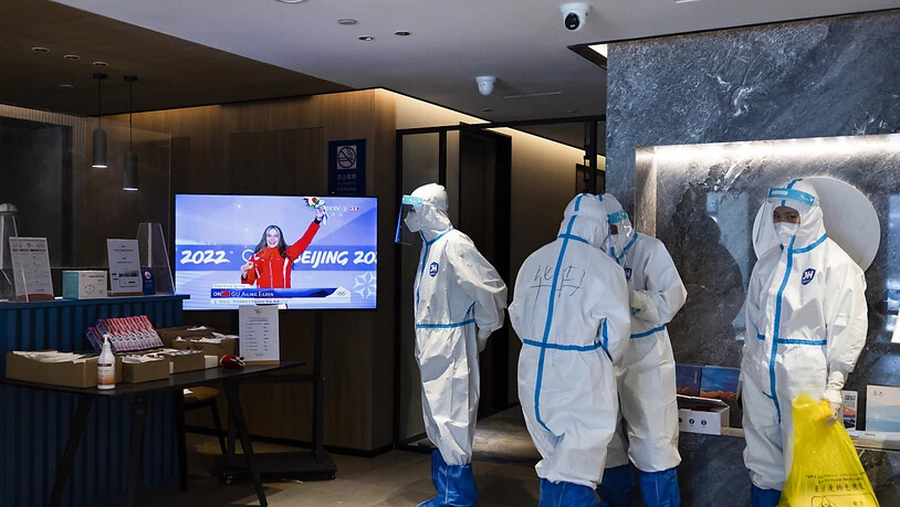 Helfer im Hotel verfolgen eine Medaillenzeremonie mit Chinas Superstar Eileen Gu