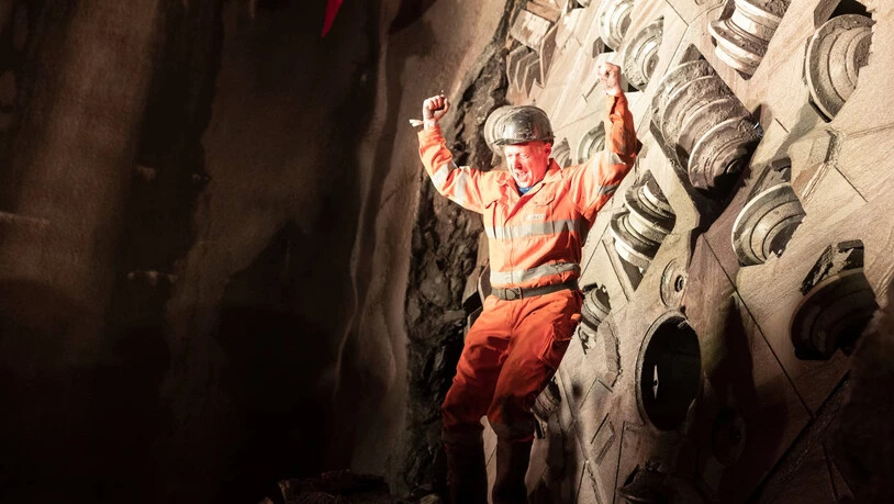 Sie haben es nach 13 Monaten geschafft: Ein Mineur jubelt, nachdem er durch das kleine Loch in der Tunnelbohrmaschine geklettert ist. 