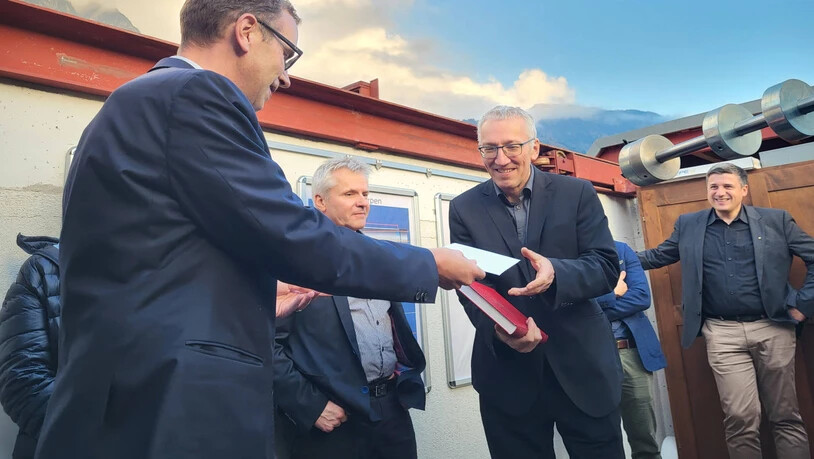 Dankeschön: Regierungsrat Markus Heer (links) übergibt dem abgetretenen Rektor der Kantonsschule, Peter Aebli, ein Präsent.