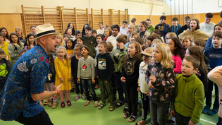 Dodo übt mit den 100 Schülerinnen und Schülern der Schule Sedrun für den Auftritt auf dem Oberalppass beim Leuchtturm vom 19. März.
