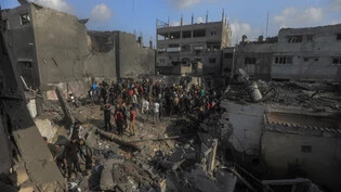 Palästinenser begutachten die Schäden nach einem israelischen Luftangriff im südlichen Gazastreifen. Foto: Mohammed Talatene/dpa